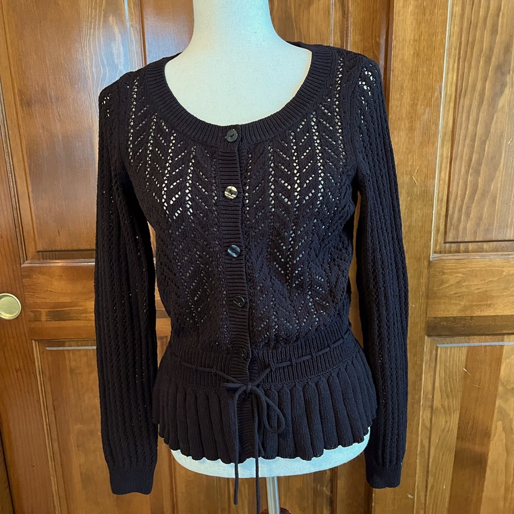 Crocheted, scoop neck cardigan with defined waist and peplum with a tie closure